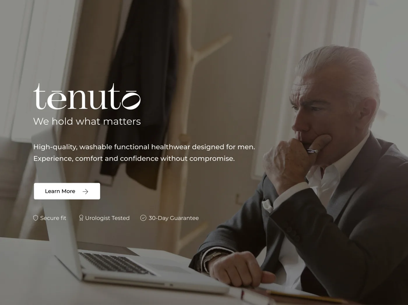Desktop banner: white logo, motto, product description, Learn more button and three keywords over a darkened photo of a grey-haired man at a laptop